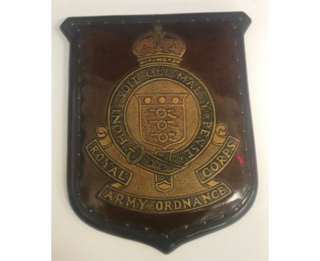 An early 20th Century plaque with leather embossed decoration inscribed "Royal Army Ordnance Corps Honi Soi Qui Mal Y Pense",