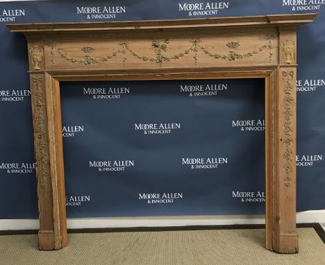 A 20th Century pitch pine fire surround with applied gesso type decoration of love birds and floral swags, ribbons and corone