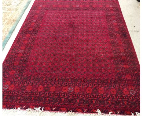 A Turkaman rug, the central panel set with multiple rows of elephant foot medallion interspersed with stylised tarantula moti