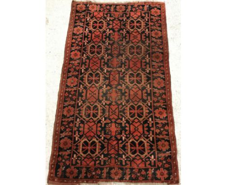 A Beshir rug, the central panel set with repeating geometric designs on a dark black ground, within a stepped geometric patte