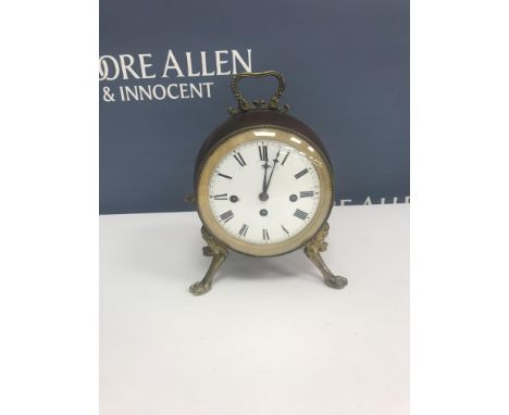 A 19th Century French drum clock with brass embellishments, the circular enamel dial with Roman numerals enclosing three wind