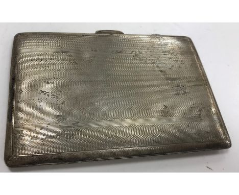 A silver cigarette case with engine turned decoration bearing initials HH inscribed to the interior "To Hugh to remind him th