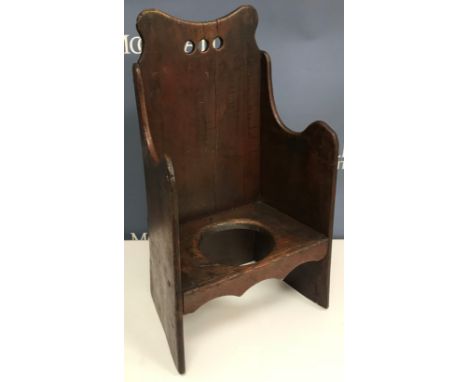A 19th Century Welsh child's commode arm chair with shaped back and arms, 32.5 cm wide x 58.5 cm high