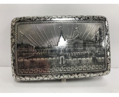 A late 19th Century Niello decorated silver snuff box, the cover decorated with "The Kremlin" within a scrolling foliate band