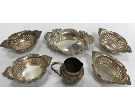 A set of four pierced and embossed sterling silver oval sweetmeat dishes 9.6 cm x 6.4 cm x 2.6 cm high, another similar embos