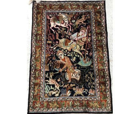 A Persian pictorial rug, the central panel set with figures hunting on horseback on a dark blue ground within a stepped cream