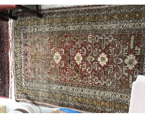 A Caucasian rug, the central panel set with stylised floral and animal motifs on a red ground within a stepped red, cream and