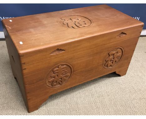 A modern Eastern teak camphor lined trunk with Oriental script medallion decoration 91 cm wide x 45 cm deep x 50 cm high toge