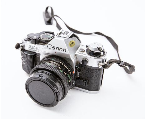 A Canon AE-1 Program 35mm SLR camera: fitted with Canon  FD 50mm 1:1.8 lens
