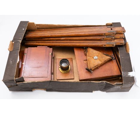 An Edwardian mahogany and brass three quarter plate camera: unsigned, together with tree plate carriers and tripod. 
