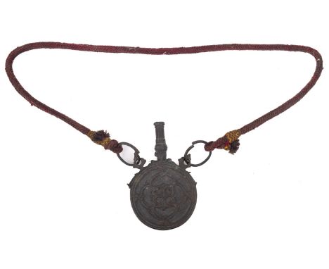 A 19th century Indo-Persian  circular copper powder flask, with foliate decoration  on a woven suspension, 10.5cm diameter.