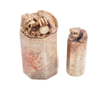 A Chinese carved hardstone steal: of octagonal outline, surmounted by a reclining dragon holding a pearl, the sides incised w