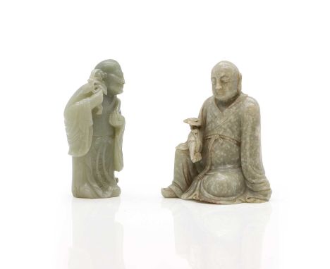 Two Chinese jade monks, 20th century, comprising:a seated example wearing a long robe with a ruyi sceptre in his right hand, 