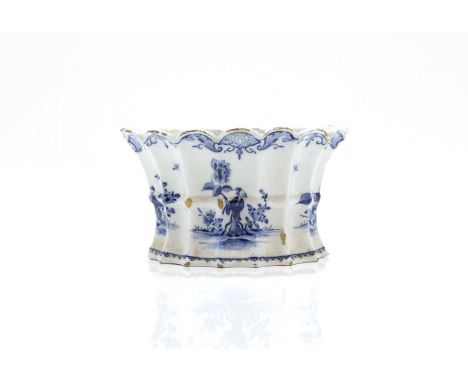 A Delft blue and white pottery flower trough, 18th century, of scallop demi-lune form, with fifteen perforations, decorated w