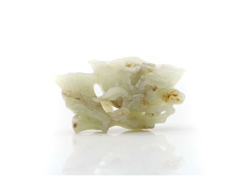 A Chinese jade carving, 20th century, in the shape of a lingzhi surrounded by smaller examples, 10cm longCondition ReportSmal
