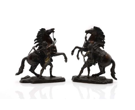 A pair of patinated bronze sculptures, early 20th century, likely French, each modelled as a horse and handler, unmarked,32cm