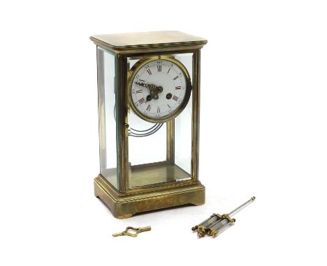 A mercurial pendulum mantel clock early 20th century, with white enamel dial and red Roman numerals, with mercurial pendulum,