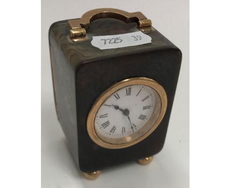 An early 20th Century French tortoiseshell cased and 9 carat gold mounted bedside clock, the movement inscribed "French movem