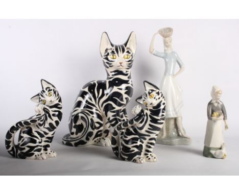 An Italian ceramic model of a black and white cat, a pair of matching kittens and two Lladro style figures of ladies