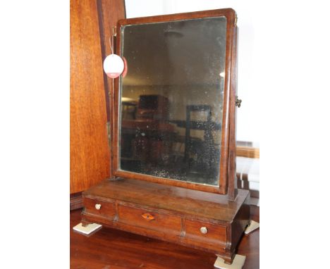 A Georgian mahogany rectangular dressing mirror, on rectangular base fitted three drawers, on ogee bracket supports, 17" wide