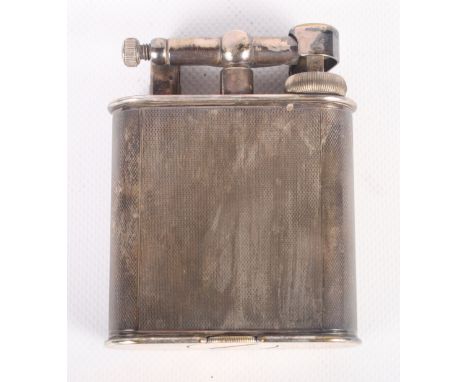 A 1930s Dunhill silver plated petrol table lighter with engine turned decoration, 4" high