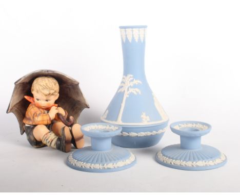 A Goebel figure of a boy under an umbrella, a pair of Wedgwood pale blue jasperware squat candlesticks and a Wedgwood blue ja