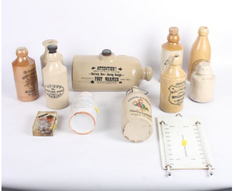 Eight stoneware beer bottles, various, a similar foot warmer, a wet and dry thermometer and a paperweight