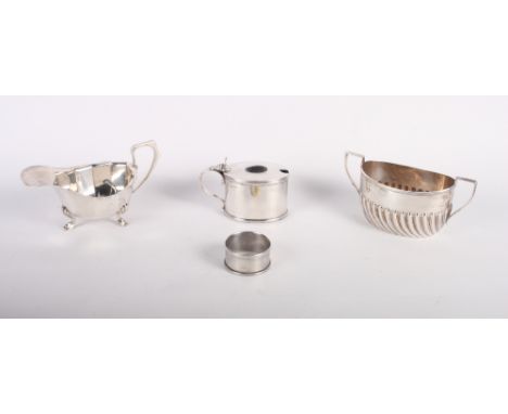 A Queen Anne design silver sugar basin, a gravy boat, a mustard pot with blue glass liner and a napkin ring, 8.8oz troy appro