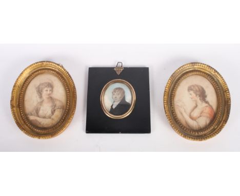 An early 19th Century oval miniature portrait of a gentleman in black coat, 2 3/4" x 2 1/4", in ebonised papier-mache frame, 