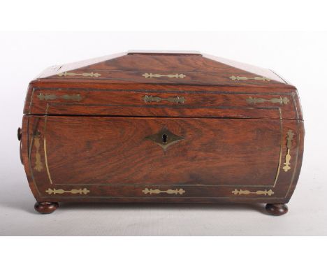A 19th Century mahogany sarcophagus shaped two-compartment tea caddy decorated cut brasswork, two wooden ring handles, on bun