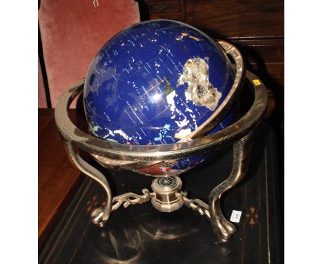 A terrestrial globe with inlaid coloured marble and mother-of-pearl, etc, on brass stand with inset compass, 18" high