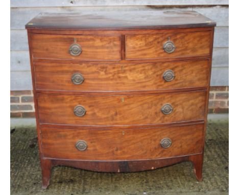 A 19th Century mahogany bowfront chest of two short and three long drawers with circular brass handles, on cut away bracket s