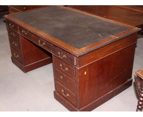 A Georgian design mahogany twin pedestal desk with inverted breakfront, fitted nine drawers, on scroll carved bracket support
