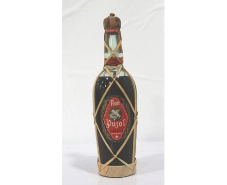 RON PUJOL C. 1950We estimate this bottle of rum as being from the 40's or early 1950's.  Ron Pujol Sociead Anonima Pujol Y Gr