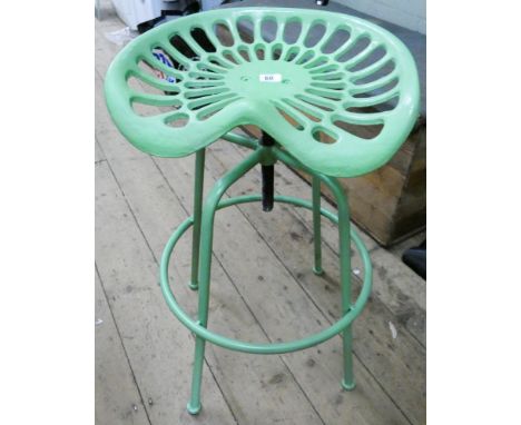 A green cast tractor seat stool 