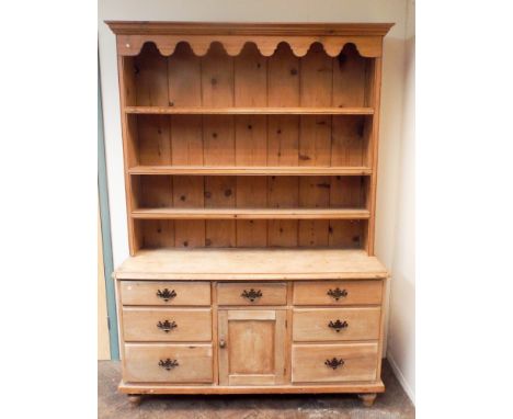 Victorian stripped pine dresser with shelf back, seven drawers and centre cupboard under. 4'9" wide      Height - 204cmDepth 