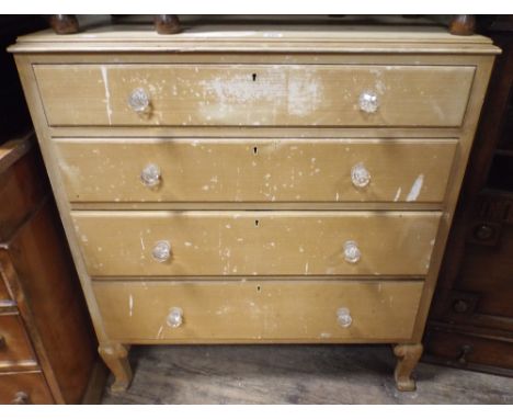 A vintage chest of four long drawers with glass handles 