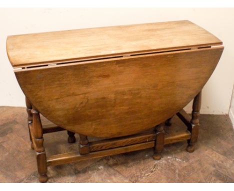 Waring & Gillows 1950's circular oak gate leg dining table on turned legs, 3'9" diameter 