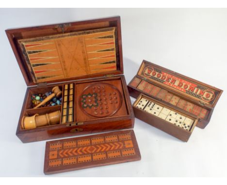 A collection of various games and games boxes to include Domino's, Back Gammon, cribbage board, Tiddly winks etc 