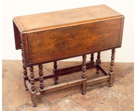 Oak gate legged dining table with carved edge standing on bobbin turn legs, 2'9" wide 