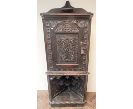 Late Victorian carved dark oak corner cabinet with cupboard top, open bottom section with shelf 