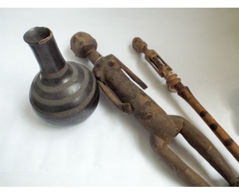 Carved wood African figure, carved wood walking stick and a pottery vase 