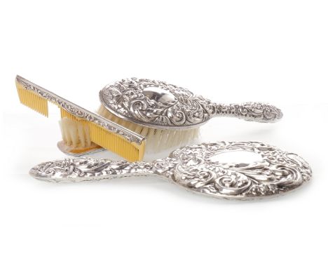 ELIZABETH II SILVER BACKED VANITY SETmaker W. I. Broadway & Co., Birmingham 1972, comprising hand mirror, two brushes and a c