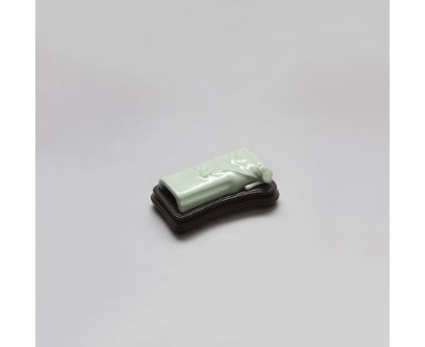A CELADON GLAZED BRUSHREST QIANLONG PERIOD ( 1736 - 1795 ) Modelled as a section of bamboo, decorated with a leafy sprig and 