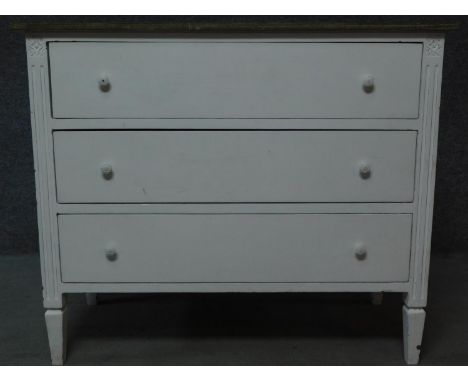 A white painted Continental style three drawer commode with limed oak top. H.89 W.106 D.49cm 