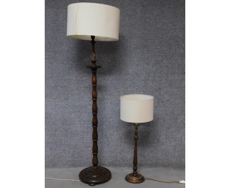 An oak turned standard lamp with circular base along with an oak turned table lamp with rope detailing and brass repousse fit