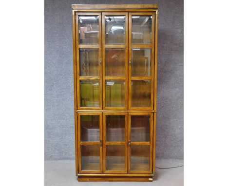 An American walnut floor standing brass bound library bookcase fitted with bevelled glass panel doors. H.199 W.92 D.39cm 