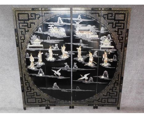 A Japanese mother of pearl and bone inlaid black lacquered three fold and four panel screen. H.183 W.185cm 