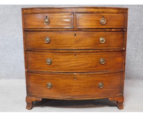 A Georgian mahogany and ebony strung bowfronted chest of two short over three long drawers on shaped bracket feet. H.93 W.92 