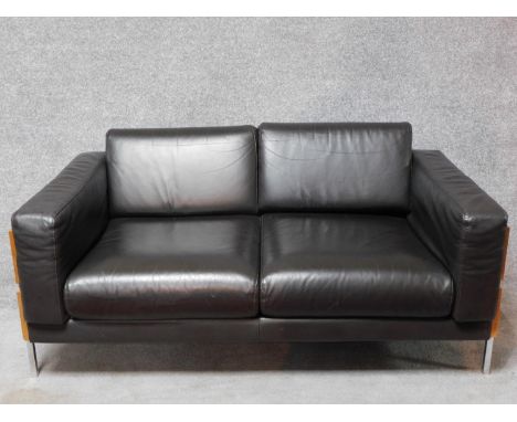 A two seater Robin Day Forum sofa in dark tan leather upholstery H.65 W.150 D.85cm 